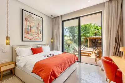 a bedroom with a bed and a sliding glass door at Villa Aila Elegant 6 Bedrooms Spa, Cinema Pool in Marrakech