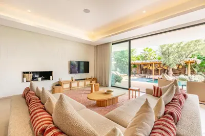 a living room with a couch and a table at Villa Aila Elegant 6 Bedrooms Spa, Cinema Pool in Marrakech