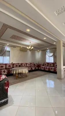 a large room with red couches and a table at Espace Dar Es Saadâ in Marrakech