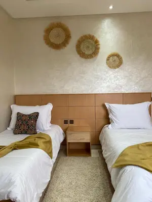 two beds sitting next to each other in a room at Espace Dar Es Saadâ in Marrakech