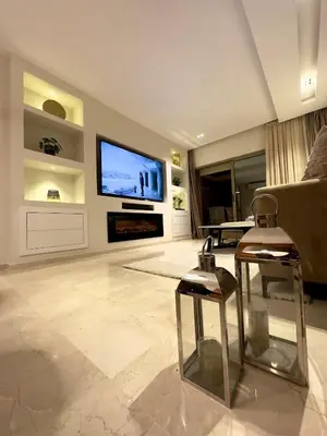 a living room with a couch and a television at Prestigia Marrakech luxury 015 in Marrakech