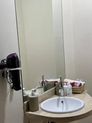 a bathroom with a sink and a mirror at Appartement charmant au cœur de Marrakech in Marrakech