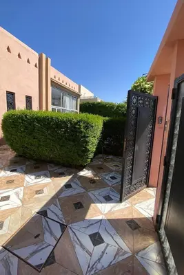 a entrance to a building with a door and bushes at Villa Marrakech avec Piscine in Marrakech
