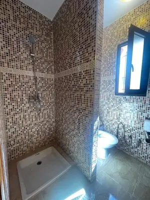 a bathroom with a shower and a toilet and a sink at Villa Marrakech avec Piscine in Marrakech