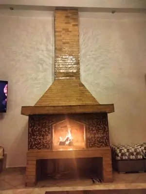 a fireplace in a living room with a fire in it at Villa Marrakech avec Piscine in Marrakech