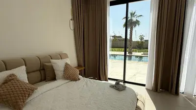 a bedroom with a bed and a view of a pool at Villa Enja - Swimming pool - 4 BR BA - Wi-Fi - Parking in Marrakech