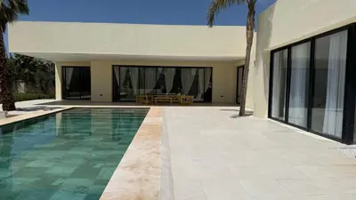 a villa with a swimming pool and a house at Villa Enja - Swimming pool - 4 BR BA - Wi-Fi - Parking in Marrakech
