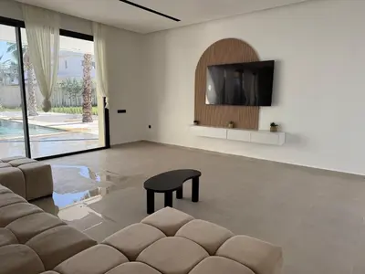 a living room with a couch and a tv at Villa Enja - Swimming pool - 4 BR BA - Wi-Fi - Parking in Marrakech