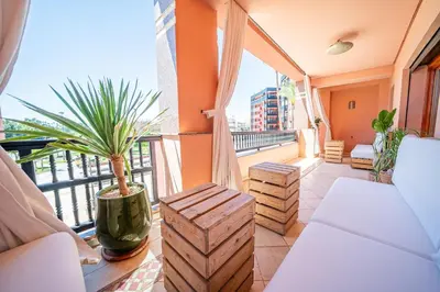 a balcony with a couch and a potted plant at luxury gueliz in Marrakech