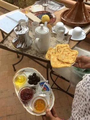 a table with a breakfast of eggs and toast at Naima's House in Marrakech