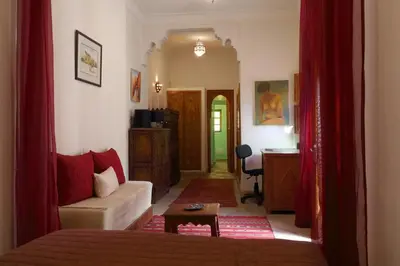 a living room with a bed and a desk in a room at Naima's House in Marrakech