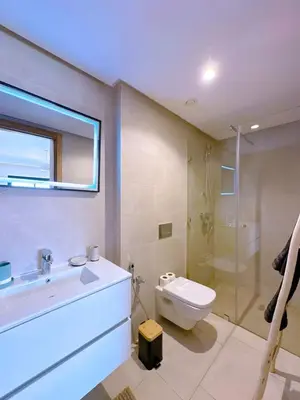 a bathroom with a sink and a toilet and a shower at New! apptÉlégance ,Lumière et Confort avec piscine in Marrakech