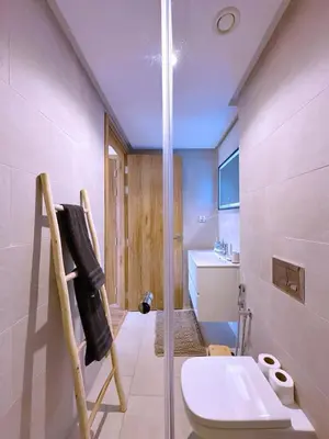a bathroom with a shower and a toilet and a sink at New! apptÉlégance ,Lumière et Confort avec piscine in Marrakech
