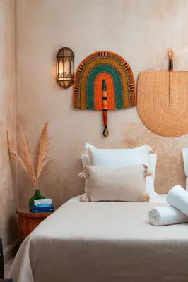 a bedroom with a bed with a rainbow on the wall at Riad Sahar Privé - Piscine Chauffée Sup - PDJ Inclus in Marrakech