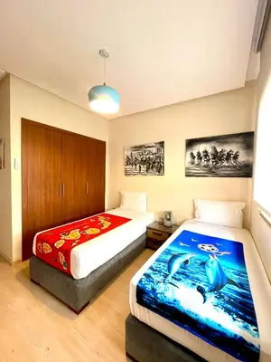 a bedroom with two beds in a room at Prestigia aghat in Marrakech