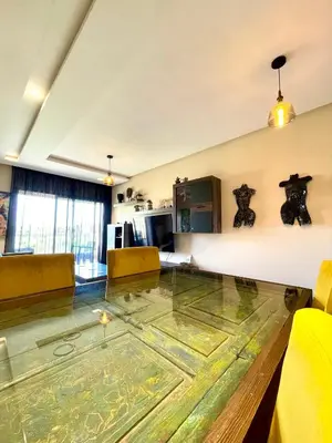 a living room with a glass table in the middle at Prestigia aghat in Marrakech