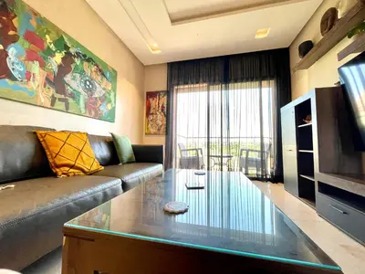 a living room with a couch and a glass coffee table at Prestigia aghat in Marrakech