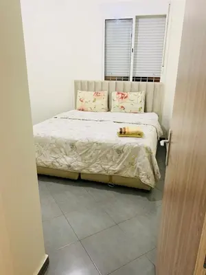 a bedroom with a large bed with a window at Spacious apartment 15 minutes from aéroport Marrakech reservation juste pour les familles est les couples mariés in Marrakech
