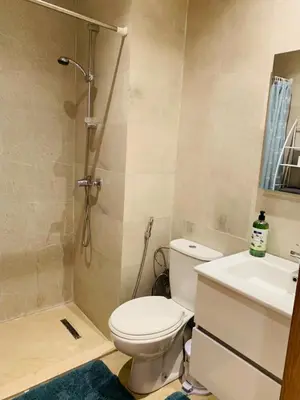 a bathroom with a shower and a toilet and a sink at Prestigious new 3-bedroom apartment with pool view in Marrakech
