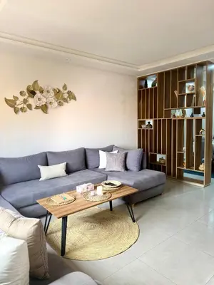 a living room with a blue couch and a coffee table at Séjour cosy à Marrakech centre in Marrakech