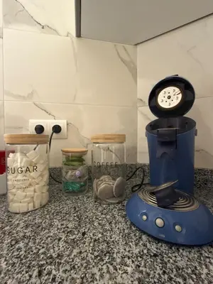 a blender sitting on a counter with a clock on it at Séjour cosy à Marrakech centre in Marrakech