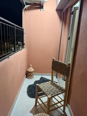 a chair sitting on a balcony with a rug at Séjour cosy à Marrakech centre in Marrakech