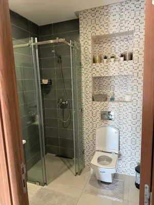 a bathroom with a toilet and a glass shower at Séjour cosy à Marrakech centre in Marrakech