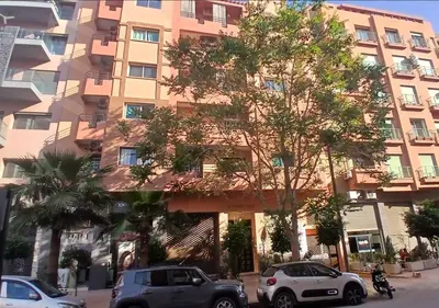 a tall building with cars parked in front of it at Walili 1 in Marrakech