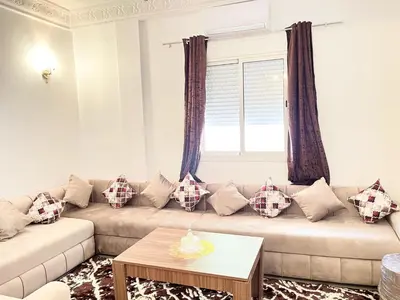 a living room with a couch and a window at luxury marrakech in Marrakech