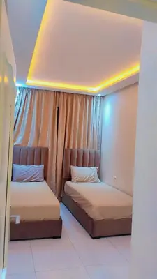 two beds in a room with a window at شقة مفروشة in Marrakech