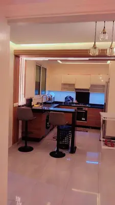 a kitchen with a desk and a sink in a room at شقة مفروشة in Marrakech