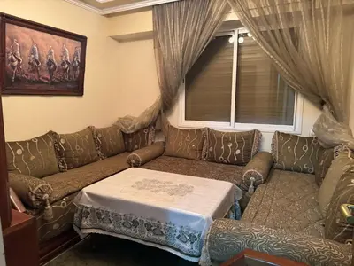 a living room with a couch with a table on it at Appartement al acadimya in Marrakech