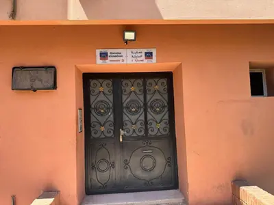 a black door on the side of a building at Appartement al acadimya in Marrakech