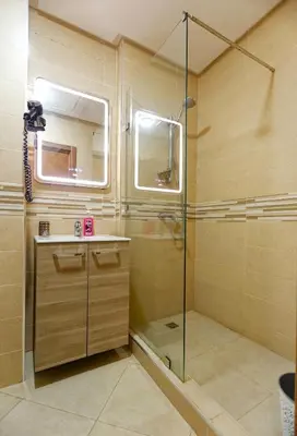 a bathroom with a shower with a glass door at Cozy Cove Marrakech in Marrakech