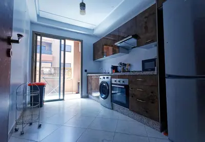 a kitchen with a washer and dryer in it at Cozy Cove Marrakech in Marrakech