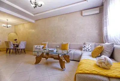 a living room with a couch and a table at Cozy Cove Marrakech in Marrakech