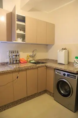 a kitchen with a sink and a washing machine at Apartment 5 minutes from Marrakech Airport in Marrakech