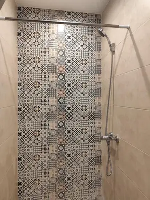 a shower in a bathroom with a mosaic shower curtain at Apartment 5 minutes from Marrakech Airport in Marrakech