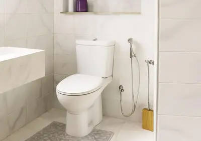 a white bathroom with a toilet and a shower at Appart Walili in Marrakech