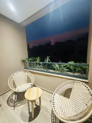 two chairs and a table in front of a window at 3 bedroom apartment in Marrakech