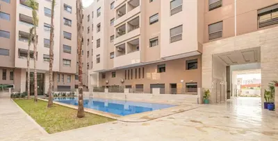an apartment building with a swimming pool in a courtyard at 3 bedroom apartment in Marrakech
