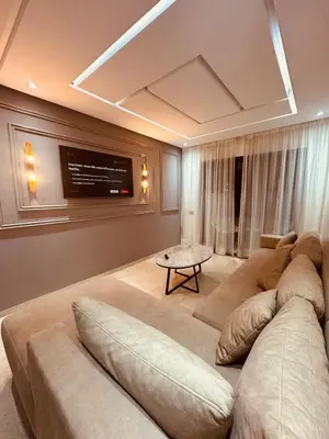 a living room with a large couch and a tv at 3 bedroom apartment in Marrakech