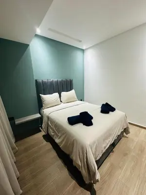 a bedroom with a large bed with two robes on it at 3 bedroom apartment in Marrakech