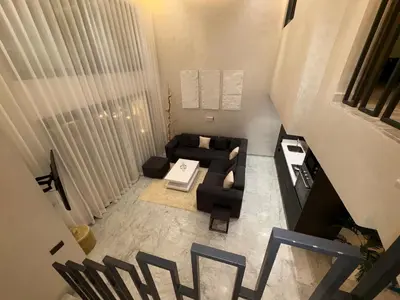 an overhead view of a living room with a couch and chairs at Magnifique loft haut de gamme avec grande terrasse zen et fontaine murale situé en plein centre-ville de Marrakech dans le cœur du quartier Gueliz à proximité des rues commerçantes et animées du Carré Eden et du Plaza Dépôt de garantie obligatoire in Marrakech