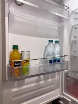 an open refrigerator with bottles of milk and juice at Magnifique loft haut de gamme avec grande terrasse zen et fontaine murale situé en plein centre-ville de Marrakech dans le cœur du quartier Gueliz à proximité des rues commerçantes et animées du Carré Eden et du Plaza Dépôt de garantie obligatoire in Marrakech