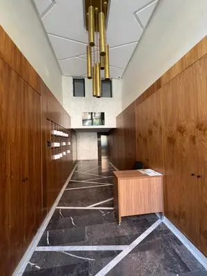 a hallway with wooden walls and a desk in a building at Magnifique loft haut de gamme avec grande terrasse zen et fontaine murale situé en plein centre-ville de Marrakech dans le cœur du quartier Gueliz à proximité des rues commerçantes et animées du Carré Eden et du Plaza Dépôt de garantie obligatoire in Marrakech