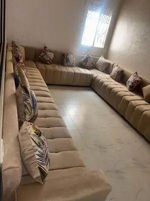 a living room with a long couch with pillows at Sousou Home in Marrakech