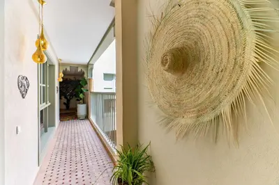 a wreath hanging on a wall next to a hallway at Riad 26 in Marrakech
