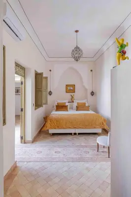 a bedroom with a large bed in a room at Riad Bayda in Marrakech