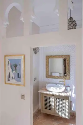 a bathroom with a sink and a mirror at Riad Bayda in Marrakech